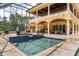 Inviting pool and spa with extensive decking and screened enclosure and covered lanai at 8590 Apache Trl, Kissimmee, FL 34747