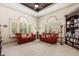 Comfortable sitting room with coffered ceiling, ceiling fan, plenty of natural light, and built in shelving at 8590 Apache Trl, Kissimmee, FL 34747