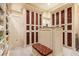 Organized walk-in closet featuring custom cabinetry and a central island, providing ample storage and sophisticated style at 8590 Apache Trl, Kissimmee, FL 34747