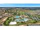 Expansive aerial of a community featuring numerous homes surrounding a luxurious pool and golf course at 8969 Stinger Dr, Davenport, FL 33896