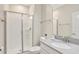 Well-lit bathroom features a glass-enclosed shower and sleek vanity with modern fixtures at 8969 Stinger Dr, Davenport, FL 33896