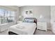 A cozy bedroom features a queen bed with fresh white linens and decorative pillows at 8969 Stinger Dr, Davenport, FL 33896