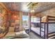Themed bedroom with bunkbeds, a queen bed, and unique brick and Harry Potter accents throughout at 8969 Stinger Dr, Davenport, FL 33896