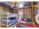 Marvel themed bedroom with bunk beds and twin bed with Marvel themed decorations at 8969 Stinger Dr, Davenport, FL 33896