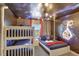 Marvel themed bedroom with bunkbeds and a queen bed with blue bedding and galaxy ceiling at 8969 Stinger Dr, Davenport, FL 33896