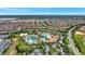 Aerial view of a large community pool complex with multiple pools, landscaping, and surrounding residences at 8969 Stinger Dr, Davenport, FL 33896
