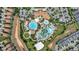 Aerial view of community pool with winding water slides, and lush tropical landscaping at 8969 Stinger Dr, Davenport, FL 33896