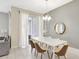 Dining room with tile floors, modern lighting, and sliding door access at 8969 Stinger Dr, Davenport, FL 33896