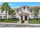 Exterior facade of townhome with tile roof and landscaping at 8969 Stinger Dr, Davenport, FL 33896