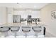 Modern kitchen featuring a large island with bar stool seating and stainless steel appliances at 8969 Stinger Dr, Davenport, FL 33896