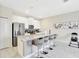 Modern kitchen with white cabinets, stainless steel appliances and a large center island at 8969 Stinger Dr, Davenport, FL 33896