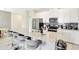 Modern kitchen featuring a large island with bar stool seating and stainless steel appliances at 8969 Stinger Dr, Davenport, FL 33896