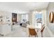 Bright living room with modern finishes, adjacent dining area, and outdoor access at 8969 Stinger Dr, Davenport, FL 33896