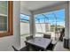Covered patio with dining set, perfect for outdoor meals and relaxation by the pool at 8969 Stinger Dr, Davenport, FL 33896