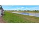 Scenic view of a tranquil pond surrounded by lush green lawns and trees at 8969 Stinger Dr, Davenport, FL 33896