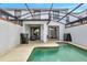 Screened in pool and lanai with seating area in backyard of home at 8969 Stinger Dr, Davenport, FL 33896