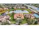 Expansive aerial view showcases estate home near the community lake, tennis courts, pool, lush landscaping, and nearby highway at 9178 Panzani Pl, Windermere, FL 34786