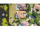 Aerial view of a tile roof, screened-in pool and a serene pond at 9178 Panzani Pl, Windermere, FL 34786