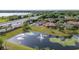 Expansive aerial view overlooking backyard pond, nearby homes and convenient access to the highway at 9178 Panzani Pl, Windermere, FL 34786