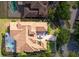 Aerial view of house with a tile roof, driveway, and a screened-in pool at 9178 Panzani Pl, Windermere, FL 34786