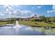 Scenic backyard featuring a beautiful pond with a fountain and lush greenery at 9178 Panzani Pl, Windermere, FL 34786