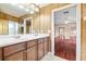 Bathroom showcasing double sinks and a doorway that reveals the home's spacious layout at 9178 Panzani Pl, Windermere, FL 34786