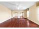Spacious bedroom featuring hardwood floors, a ceiling fan, and mirrored closet doors for ample storage at 9178 Panzani Pl, Windermere, FL 34786