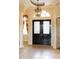Elegant home entrance with decorative glass double doors and tile flooring at 9178 Panzani Pl, Windermere, FL 34786
