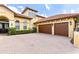 Elegant home featuring a tile roof, paved driveway, and a spacious three-car garage at 9178 Panzani Pl, Windermere, FL 34786