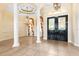 Spacious foyer with tile flooring, columns, chandelier, and ornate double doors at 9178 Panzani Pl, Windermere, FL 34786
