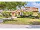 Beautiful home exterior boasts a paver driveway, a meticulously maintained lawn, lush landscaping, and a well-lit two-car garage at 9178 Panzani Pl, Windermere, FL 34786