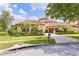 Nice home features a paver driveway, a meticulously maintained lawn, lush landscaping, and a two-car garage at 9178 Panzani Pl, Windermere, FL 34786
