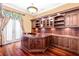 Well-appointed home office with custom built-in cabinetry and hardwood floors at 9178 Panzani Pl, Windermere, FL 34786