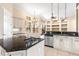 A bright kitchen features a large island with stainless steel appliances, granite countertops, and pendant lighting at 9178 Panzani Pl, Windermere, FL 34786