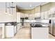 A gourmet kitchen with white cabinets, granite countertops, stainless steel appliances, and tile floors at 9178 Panzani Pl, Windermere, FL 34786