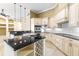 The gourmet kitchen features an island with a wine rack, granite countertops, stainless appliances, and pendant lighting at 9178 Panzani Pl, Windermere, FL 34786