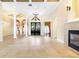 Spacious living room featuring tile floors, columns, and a fireplace at 9178 Panzani Pl, Windermere, FL 34786