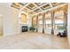Open-concept living room featuring a fireplace, tile floors, and large windows at 9178 Panzani Pl, Windermere, FL 34786