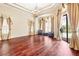 Bright living room featuring hardwood floors, stylish curtains, and comfortable seating at 9178 Panzani Pl, Windermere, FL 34786