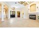 Spacious living area with fireplace, tile flooring, and elegant double-door entry at 9178 Panzani Pl, Windermere, FL 34786