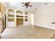 Open living room featuring tile floors, arched doorways, built-in shelves, and a ceiling fan at 9178 Panzani Pl, Windermere, FL 34786