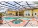 Relaxing pool and spa area surrounded by brick pavers and a screened enclosure for year-round enjoyment at 9178 Panzani Pl, Windermere, FL 34786