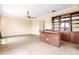 Spacious game room with a wet bar and custom built-in shelving at 9178 Panzani Pl, Windermere, FL 34786