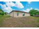 Spacious backyard featuring lush grass and a clear view of the blue sky and white clouds at 936 Dandridge Dr, Deltona, FL 32725