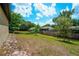 Lush backyard with vibrant trees creating a serene environment, complemented by a well-maintained lawn at 936 Dandridge Dr, Deltona, FL 32725