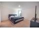 Simple bedroom with carpeted floors and a large window at 936 Dandridge Dr, Deltona, FL 32725