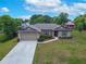 Lovely one-story home featuring a long driveway and an attached garage, complemented by a well-manicured lawn at 936 Dandridge Dr, Deltona, FL 32725