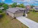 Inviting one-story home with an attached two-car garage and well-kept landscaping, offering great curb appeal at 936 Dandridge Dr, Deltona, FL 32725