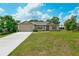 Charming one-story home with a well-manicured lawn and a long driveway at 936 Dandridge Dr, Deltona, FL 32725