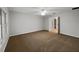 Spacious bedroom with carpet, ceiling fan, and a view to an ensuite bathroom at 9665 Se 125Th Ln, Summerfield, FL 34491